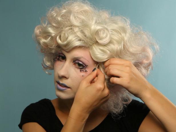 Finish the look with a wig, or curl, tease and pin your own hair to mimic Effie's short couture style. Pick up a can of temporary haircolor spray in pastel shades to make your hair distinctly Effie.