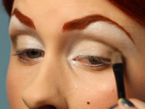 Follow with a darker brown eye shadow in the crease and blend well. The goal is to have your shadow fade from white to light brown to dark brown.