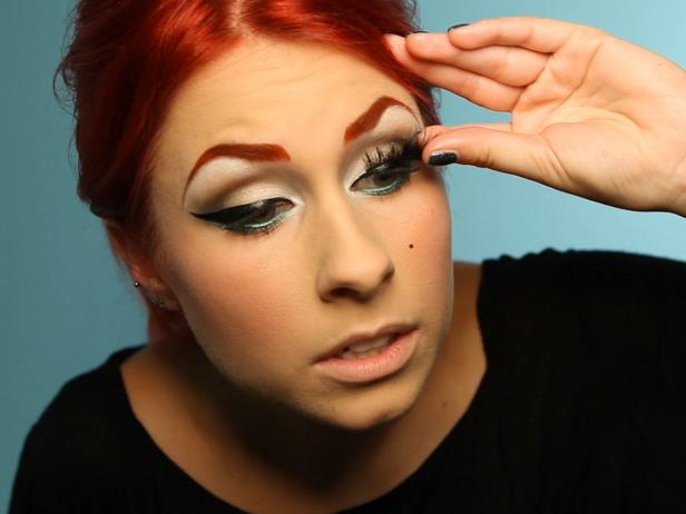 Apply false lashes, making sure the lashes are longest at the edges. Cut them to fit if necessary. Double up the lashes to make them even thicker, or purchase a pair that are doubly thick from the start.