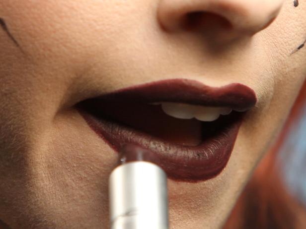 Apply dark purple liner to fill in lips. Add dark purple lipstick on top of the liner. Using liner under your lipstick will help define your lips and make your color last much longer.