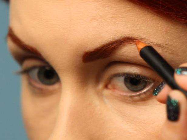 Define your eyebrows with a brownish-red liner pencil. Fake a high arch in brow by sharpening the curve at the highest point of eyebrow.