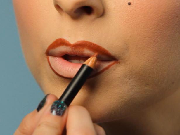Line lips with brownish-red pencil liner.
