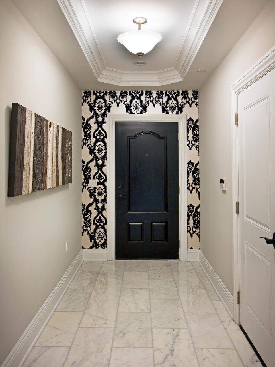 Black-and-White Entryway With Patterned Wallpaper and Marble Floor