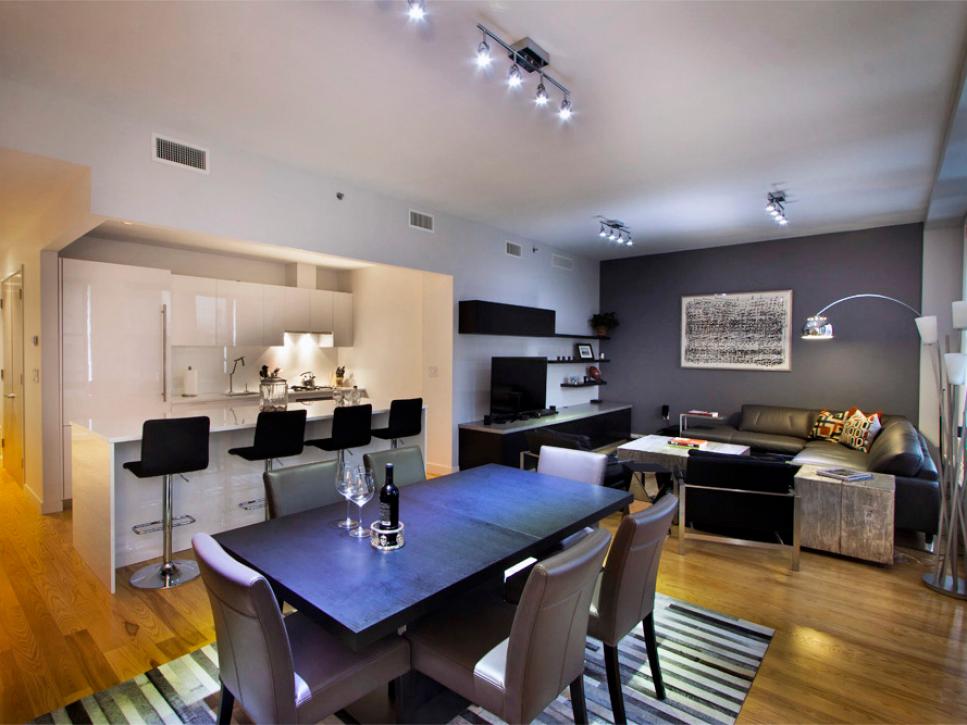 Gray Open Dining and Living Room With Leather Furniture and Breakfast Bar