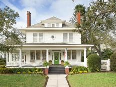 White Home with a Wraparound Porch and a Green Door