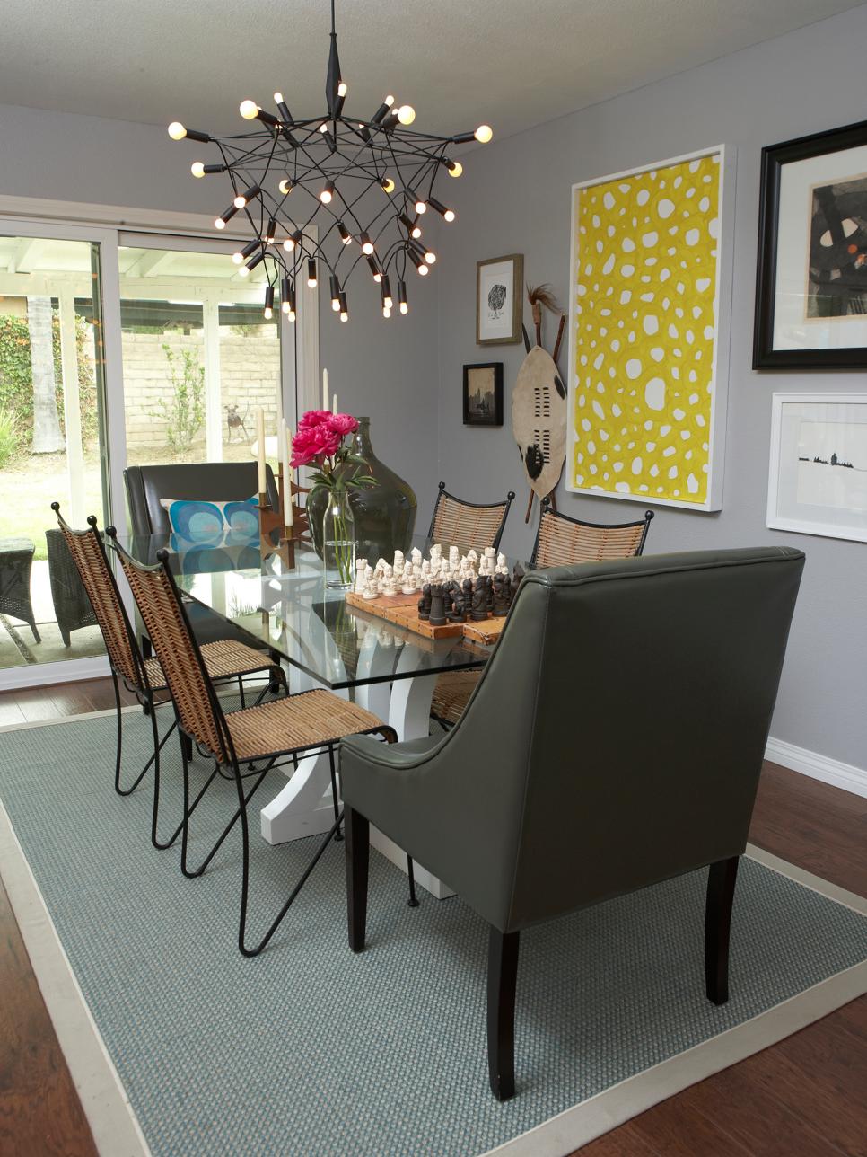 Gray Dining Room With Glass-Top Table, Metal Chandelier and Yellow Art
