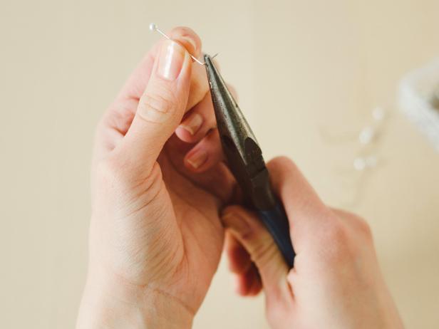 Using pliers, bend pins to create a 90-degree angle, approximately 1/3 of the length up from the pin's pointed end.