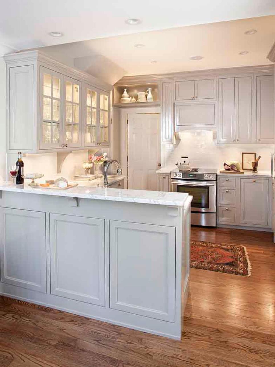 White Traditional Kitchen With Glass Cabinets and Marble Countertops