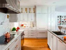 White Modern Kitchen With Marble Countertops and Inset Cabinets