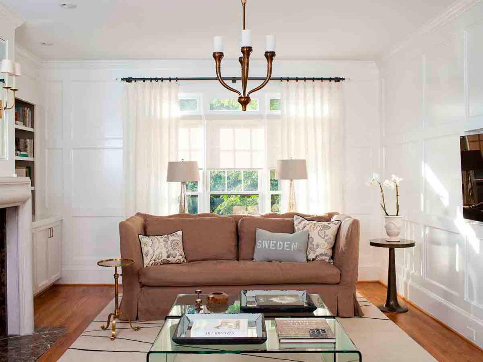 Tan Sofa and Clear Coffee Table in Transitional White Living Room