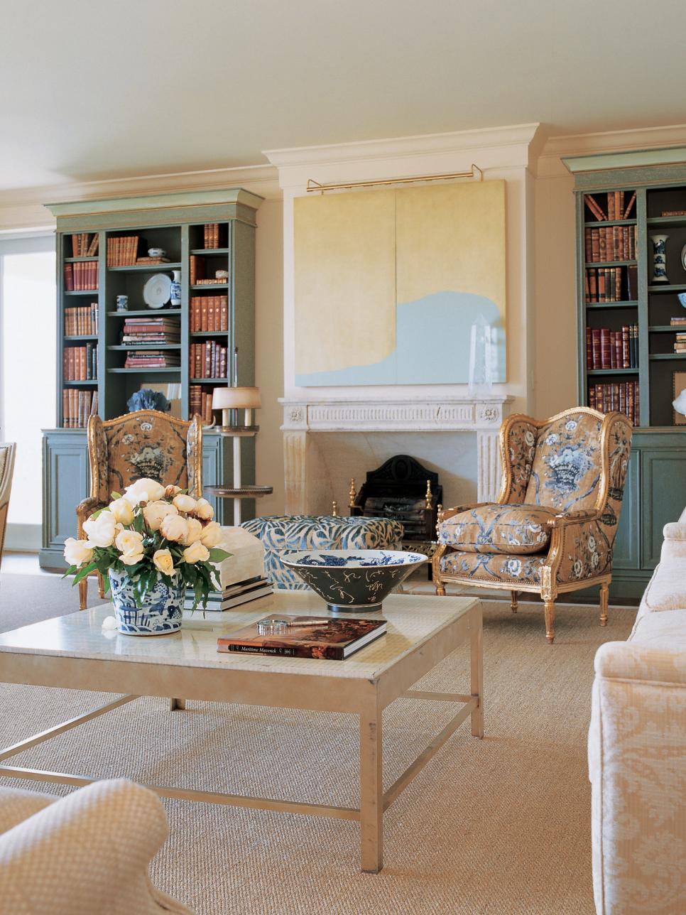 Living Room With White Limestone Fireplace and Bookcases