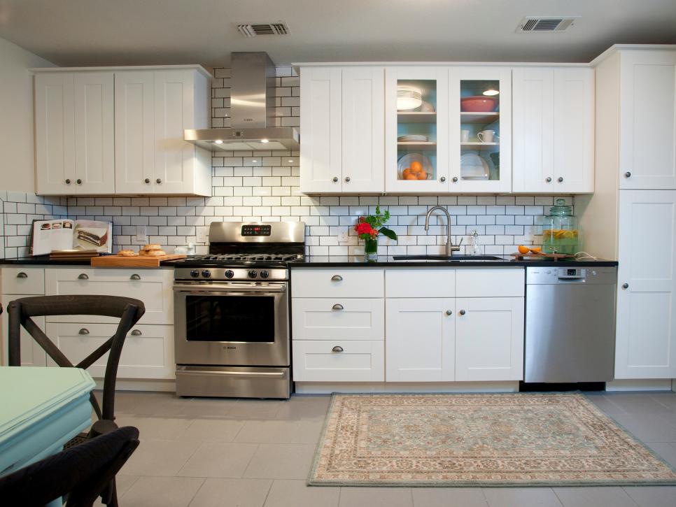 White Kitchen With Subway Tile Backsplash and Black Countertops