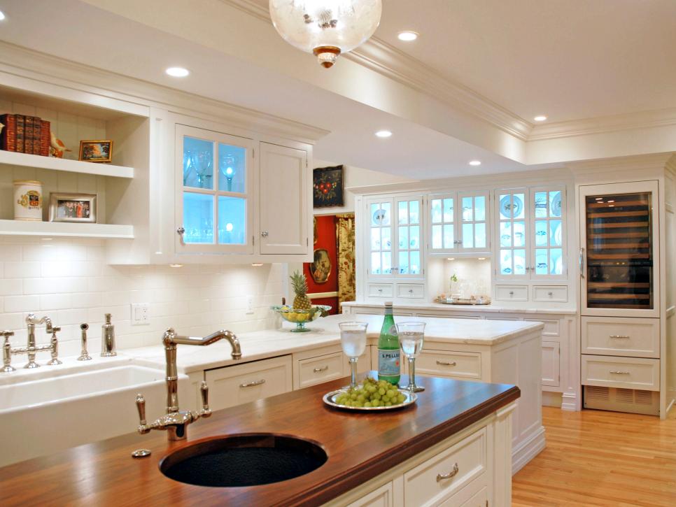 Traditional Kitchen With White Cabinetry and Walnut Island