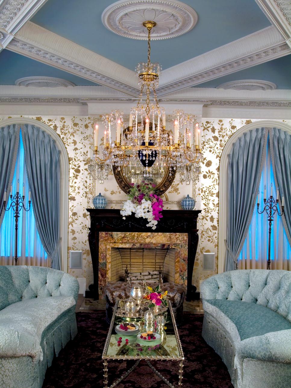 Living Room With Blue Sofas, Crystal Chandelier & Floral Wallpaper