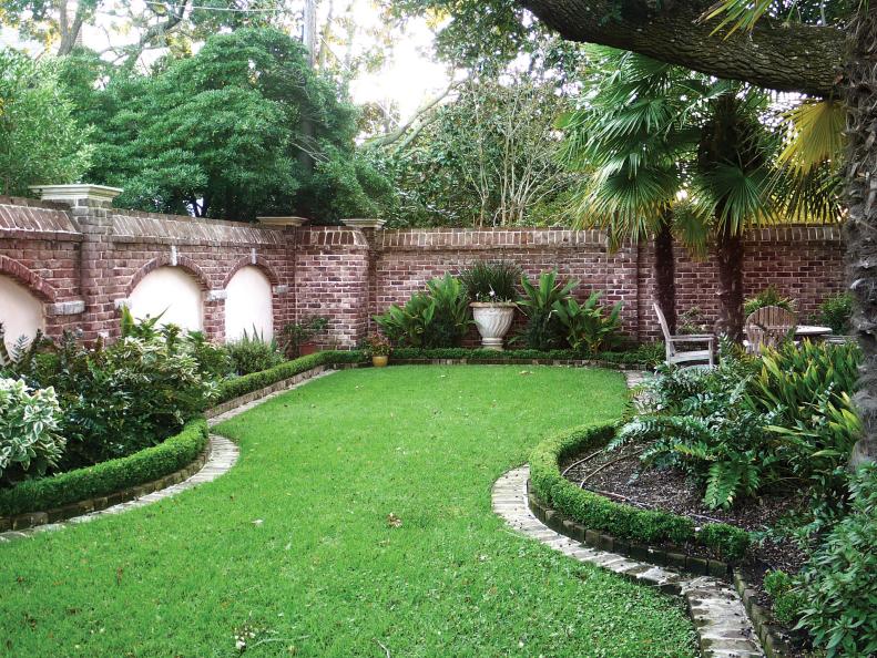 Traditional Garden Beds and Lawn Inside a Brick Wall