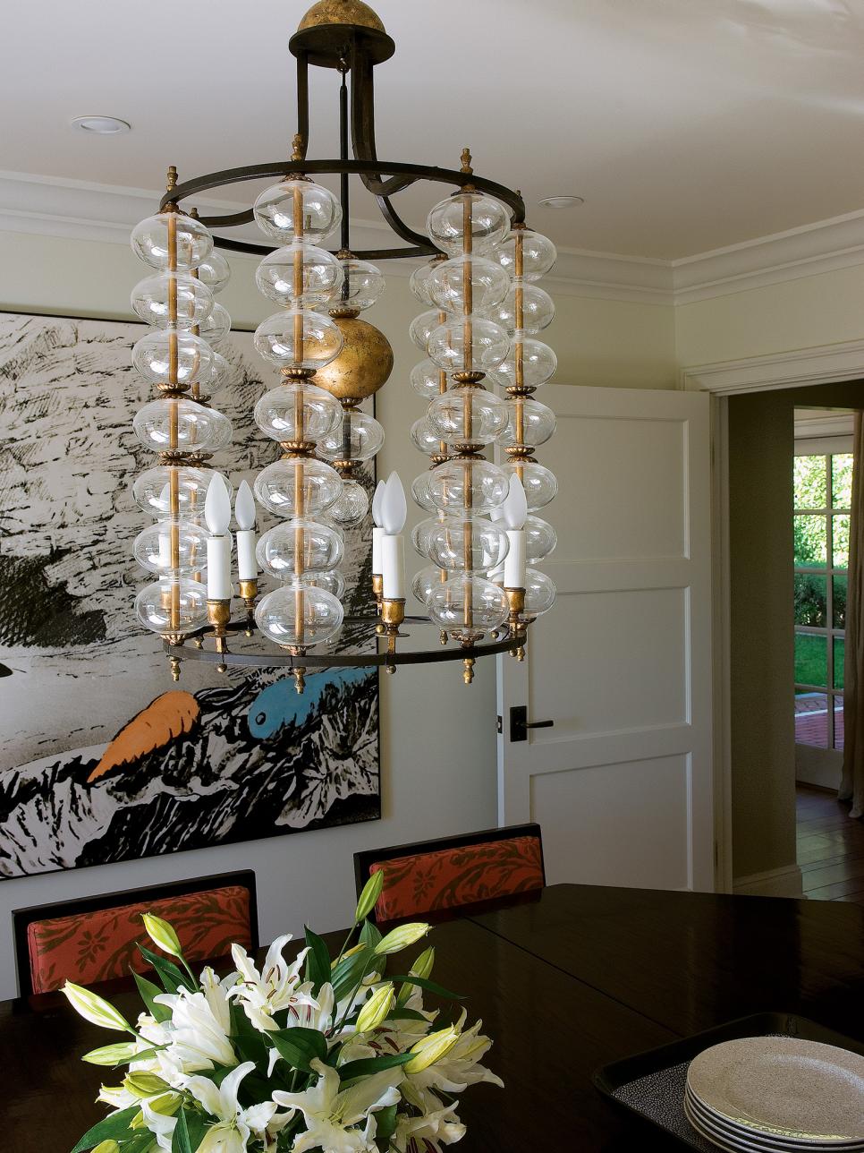 Eclectic Dining Room With Canvas Painting and Crystal Chandelier