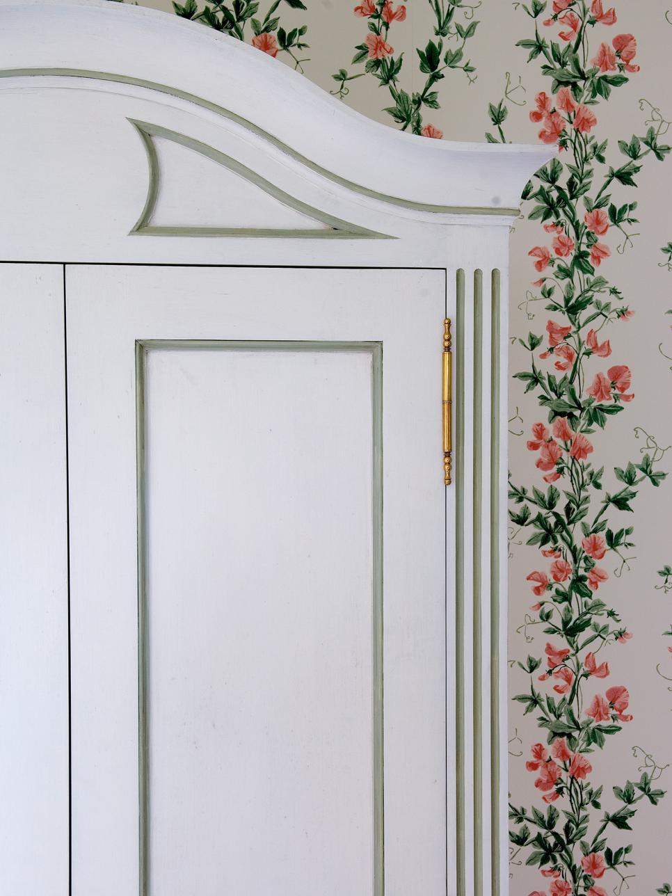 Traditional Guest Bedroom With Floral Wallpaper and White Armoire
