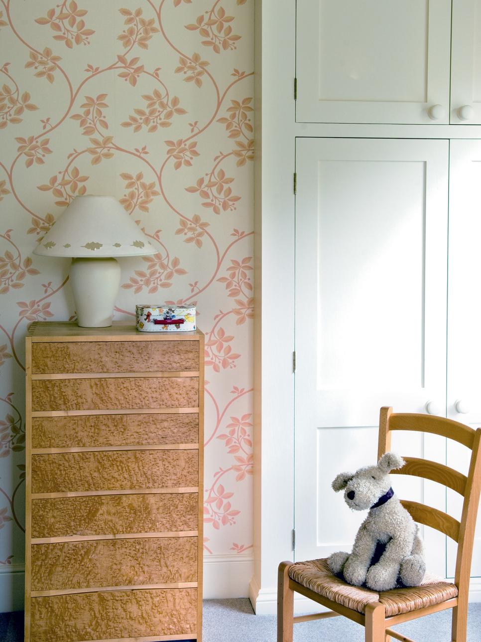 Girl's Bedroom With Floral Wallpaper and Wood Dresser