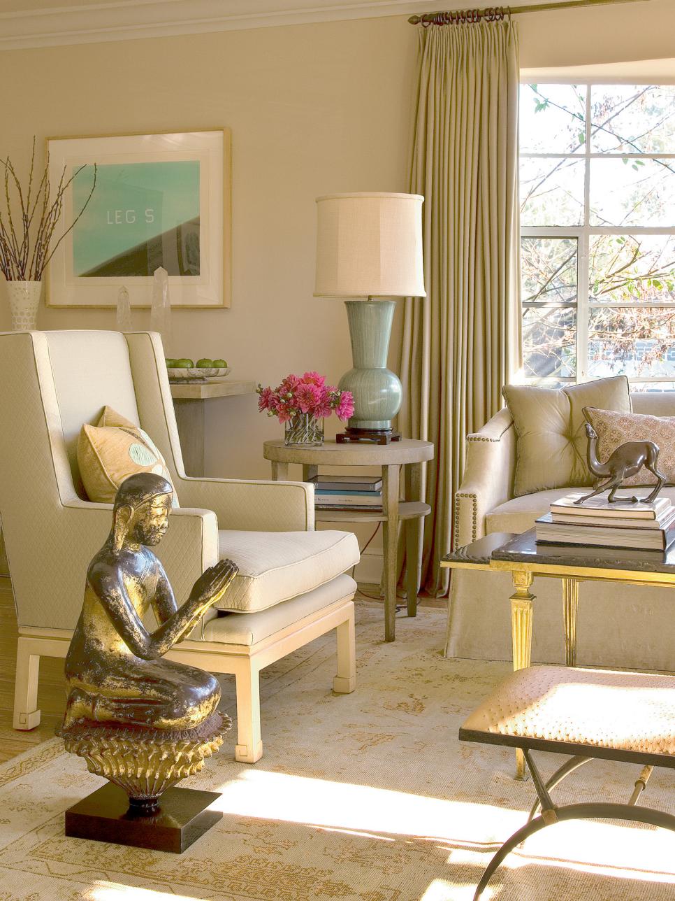 Beige Living Room With Armchair, Antique Buddha Statue & Gold Accents