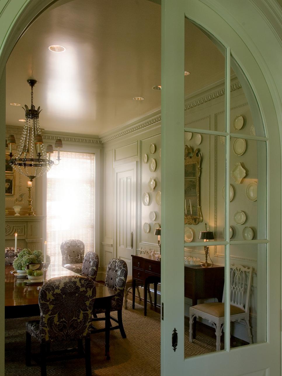 Arched Pocket Door in French Country Dining Room French Country Dining Room With Chandelier, Plate Wall, Crown Molding