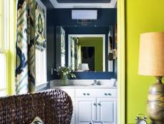 Bold Navy Bathroom With White Vanity and Patterned Roman Shade 