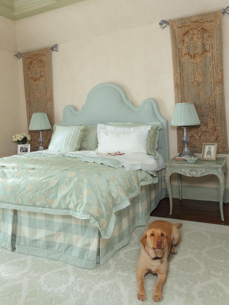 master bedroom with ornate blue headboard and family dog