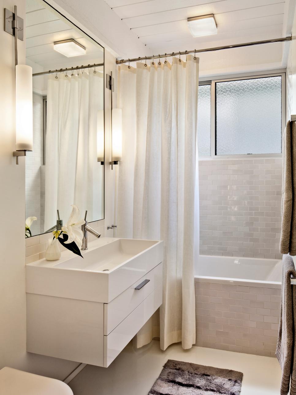 White Bathroom With Tile Shower and Floating White Sink