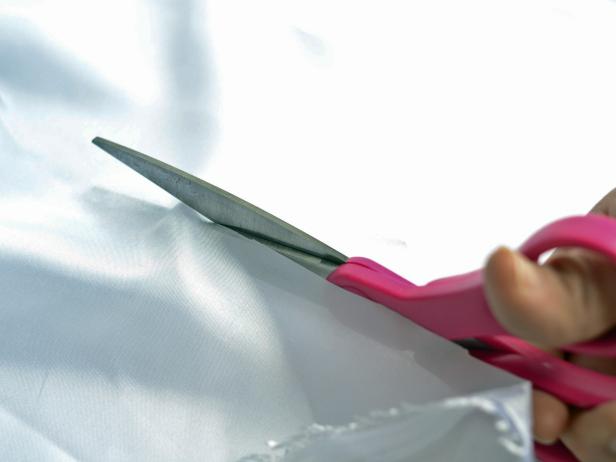 With sharp scissors, cut white imitation silk fabric width-wise into two 6-inch-wide pieces.