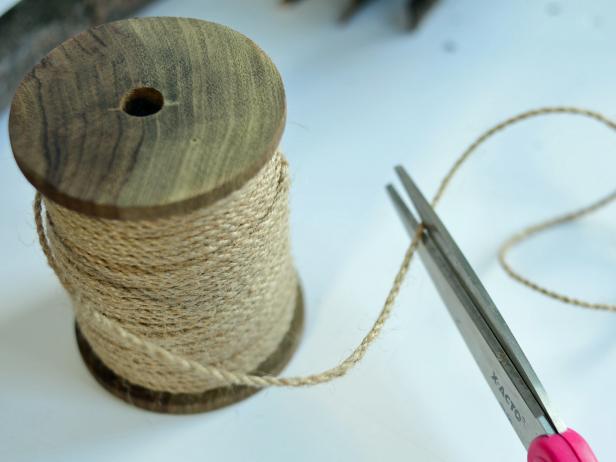 Step 7C in making a broom as an accessory for a child's Halloween witch's costume is to trim hemp twine to wrap around gathered twigs.Trim a 2-foot length of twine with a scissors.