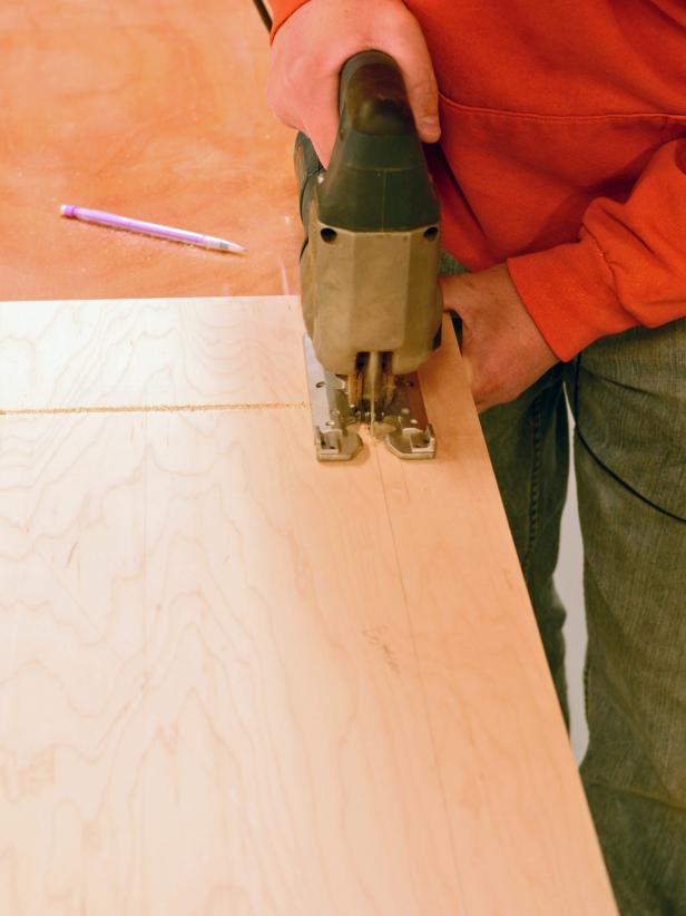 Making accurate cuts is an important step in a custom range hood job. Drill inside the area marked to be cut out with a drill bit. Insert jigsaw in hole and cut along pencil marked line. Lightly sand edges to smooth. Test-fit the exhaust fan in the cutout before assembling the range hood.