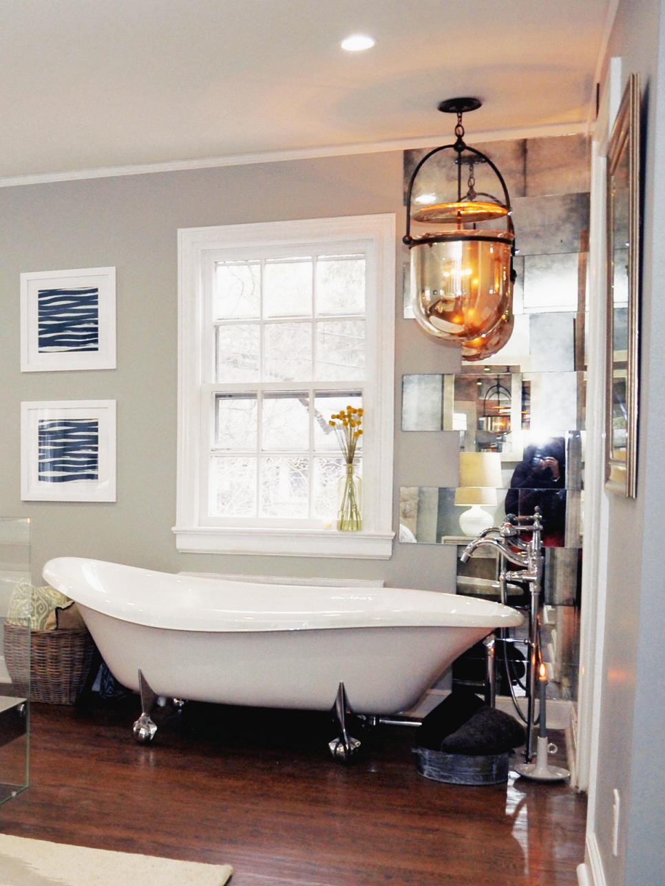 Neutral Bathroom With Clawfoot Tub, Mirrored Wall and Pendant Light