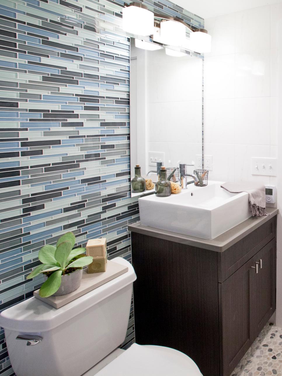 Blue Glass Tile Bathroom Wall With Brown Vanity and White Raised Sink