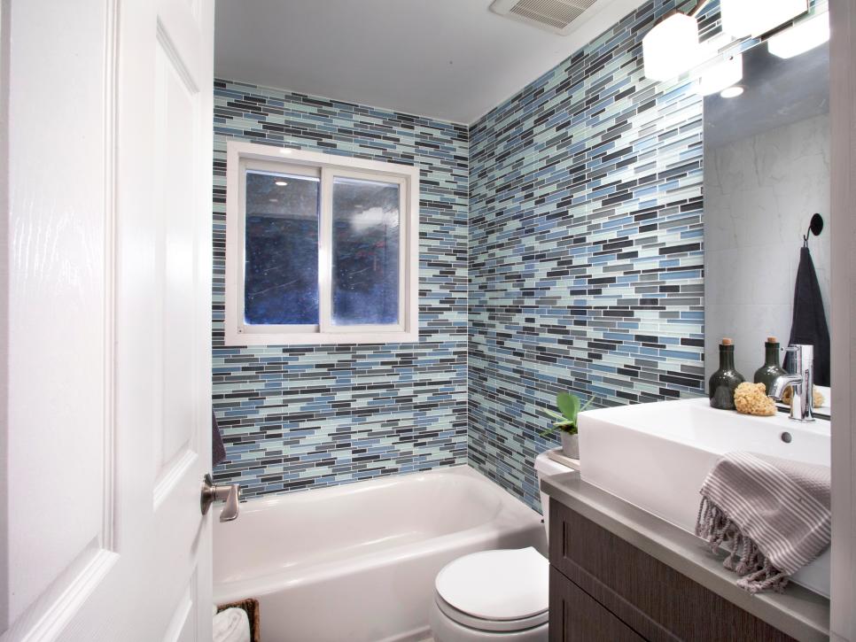 Blue and Gray Tile Shower With White Sink and Brown Vanity