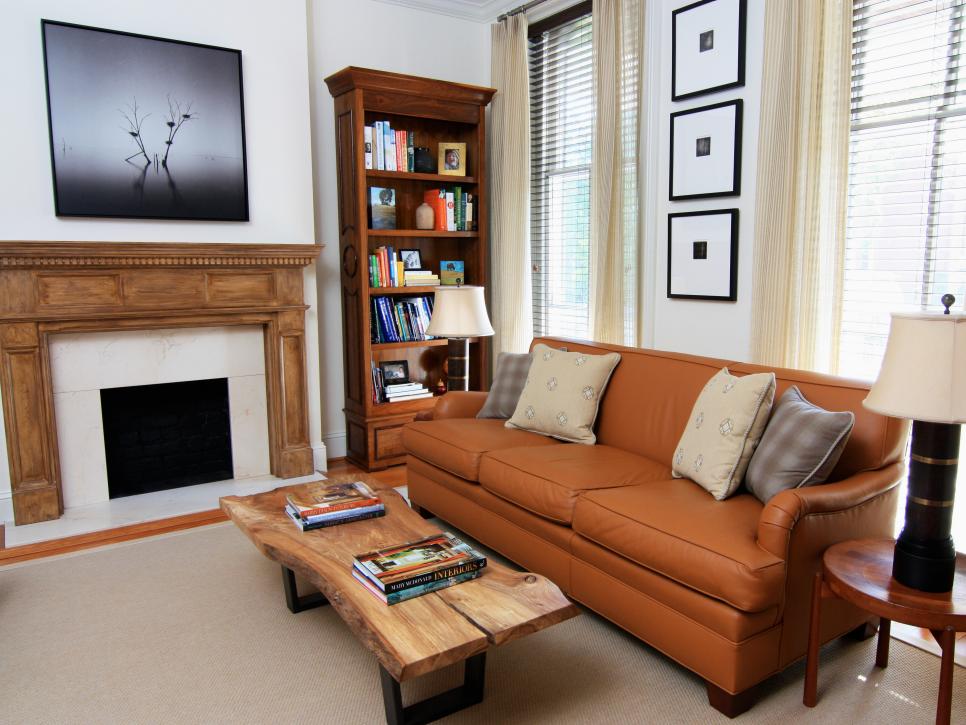 White Living Room With Brown Sofa, Wood Bookcase and Wood Slab Table