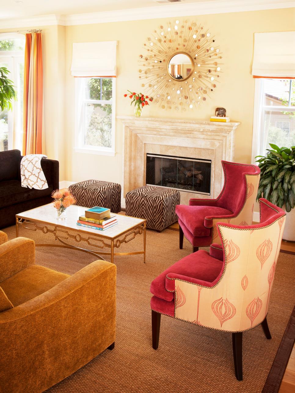 Living Room With Sunburst Mirror, Zebra Poufs, Upholstered Armchairs