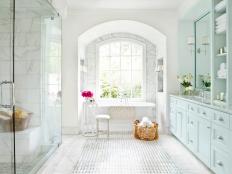 White Bathroom With Arched Window, Glass Shower and Freestanding Tub