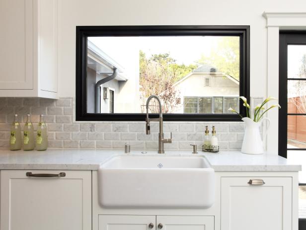White Sink With Gray Tile Backsplash, Picture Window and White Cabinets