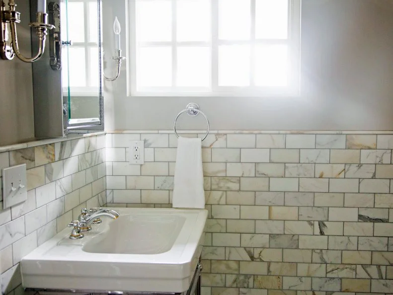 White Bathroom with Marble Wainscot, Standalone Sinks and Candle-Style Sconces