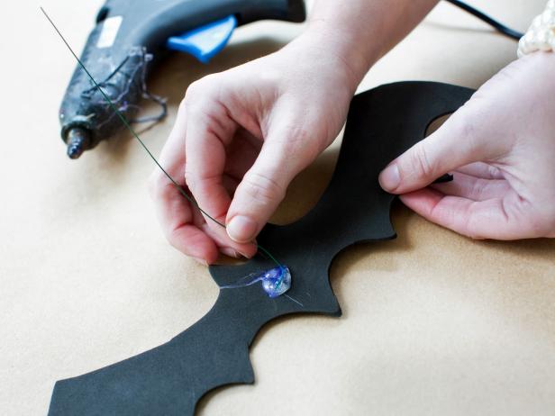 Cut floral wire into 10-inch lengths with scissors, one for each bat. Attach floral wire directly to the back of each foam bat with hot glue.