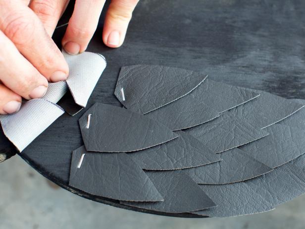 After the paint is dry, cut approximately 25 leaf-shaped feathers for each own from black vinyl. Layer them along each side of the owl silhouette, attaching them with staple gun.