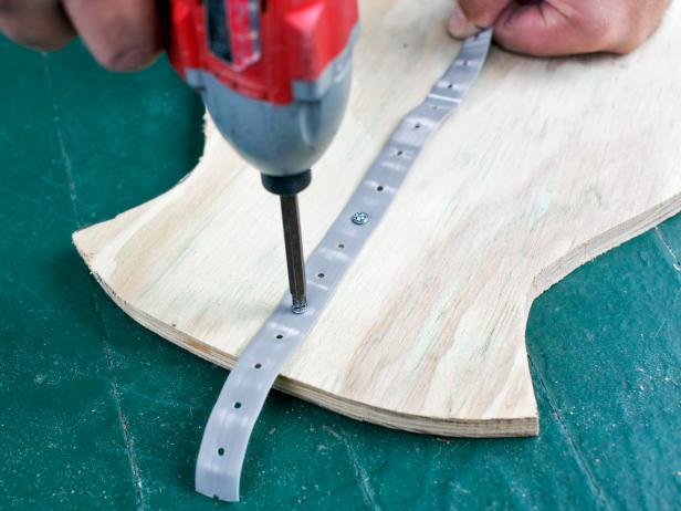 Attach PVC plumbing straps to the back side of each silhouette using 1/8" exterior screws and drill.