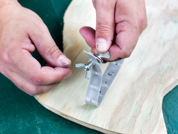 Thread wing nut and bolt through the hole created with drill bit