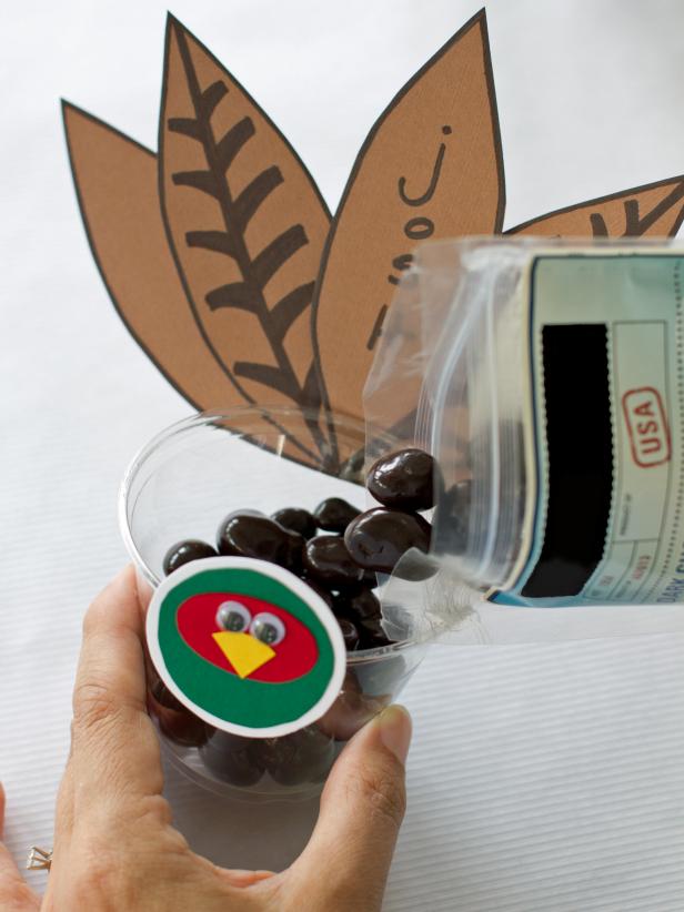 After you have put together your Thanksgiving cup place cards, fill them with the treat of your choice for guests to enjoy.