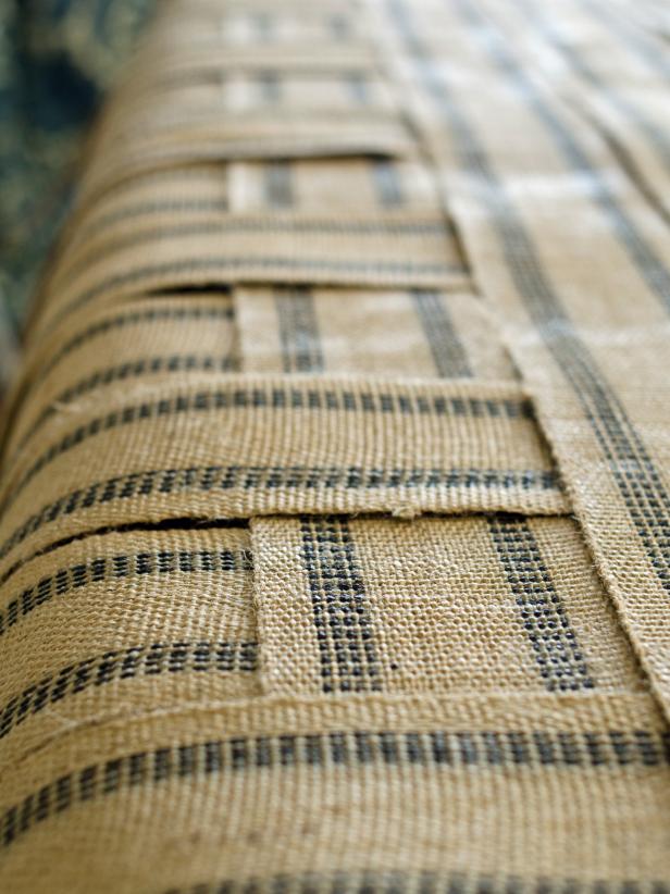 Weave first length of upholstery webbing in an over-under pattern through widths of webbing. Do this only with the first row of your table runner as shown here.