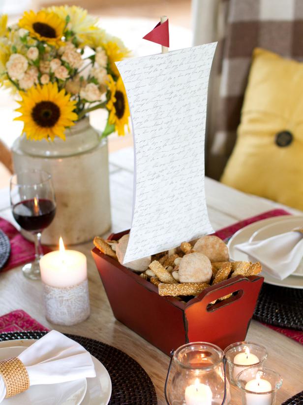 Seriously, how clever is this ship centerpiece? Follow our step-by-step instructions to learn how to make the mast and sail then place it in a long, low container filled with snacks your guests can enjoy before the big meal.