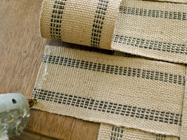To glue pieces together for the woven table runner, apply hot glue where woven webbing intersects. Press webbing down into hot glue until cooled. Tip: Only apply glue to underside of webbing where it won't be visible.