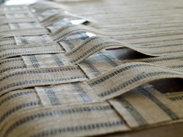 Apply hot glue where woven webbing intersects. Press webbing down into hot glue until cooled. Tip: Only apply glue to underside of webbing where it won't be visible. Repeat this process for first row until all woven sections have been securely glued. Weave second row, alternating over-under pattern.