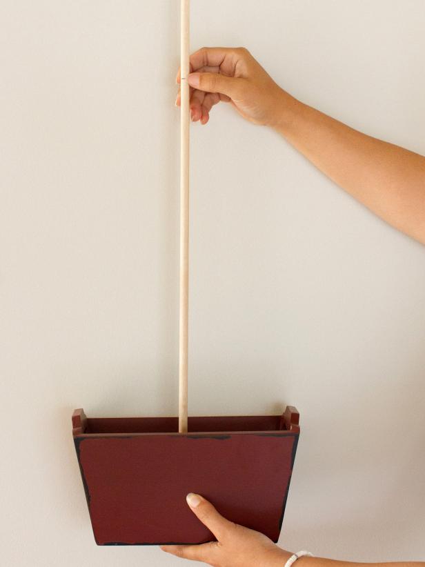 Use a miter saw to cut wooden dowel so it measures 4 times taller than the height of the serving container.