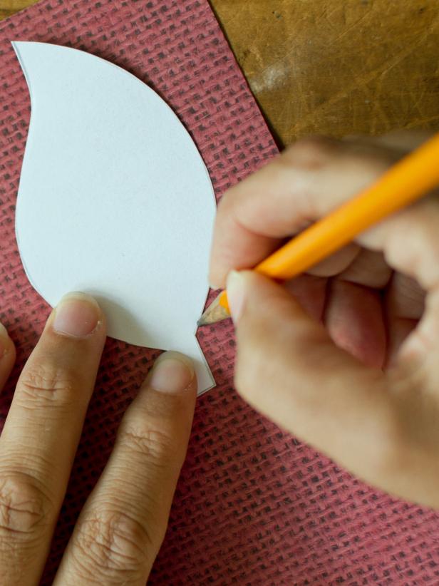 Use a pencil to trace several paper leaves on a variety of double-sided, patterned scrapbook papers. The double sided paper will ensure that your Fall centerpiece will look great from any angle.