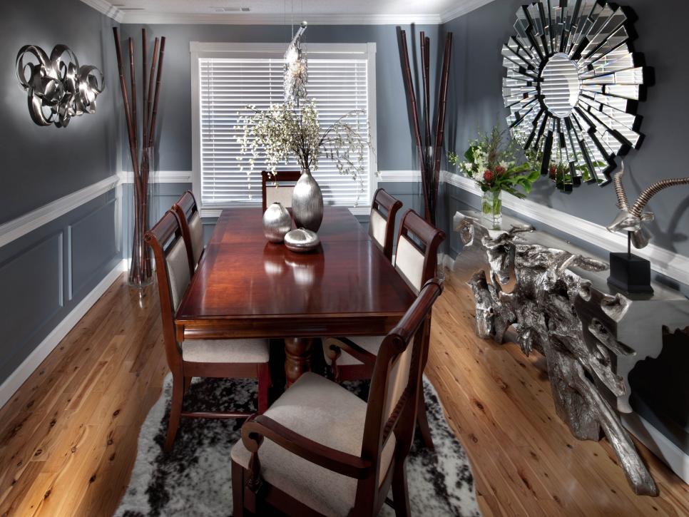 Gray Dining Room With Wood Dining Table and Silver Starburst Mirror